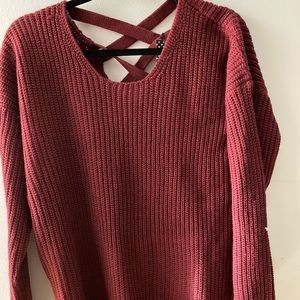 Sweater with crisscrossed work on the back